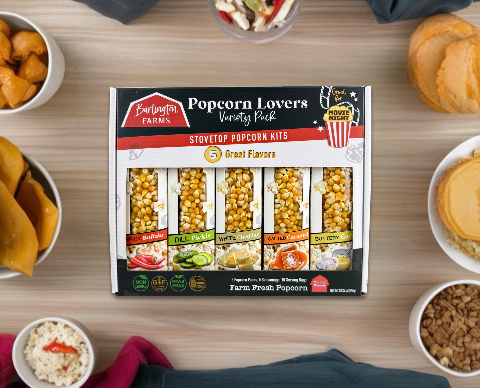 Burlington Farms Popcorn Lovers' Variety Pack on a table with popcorn and snacks.