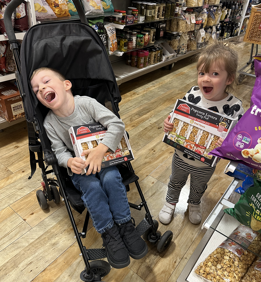 Our little popcorn fans showing excitement after finding Burlington Farms Popcorn Lovers Variety Packs on the Home Goods shelf.